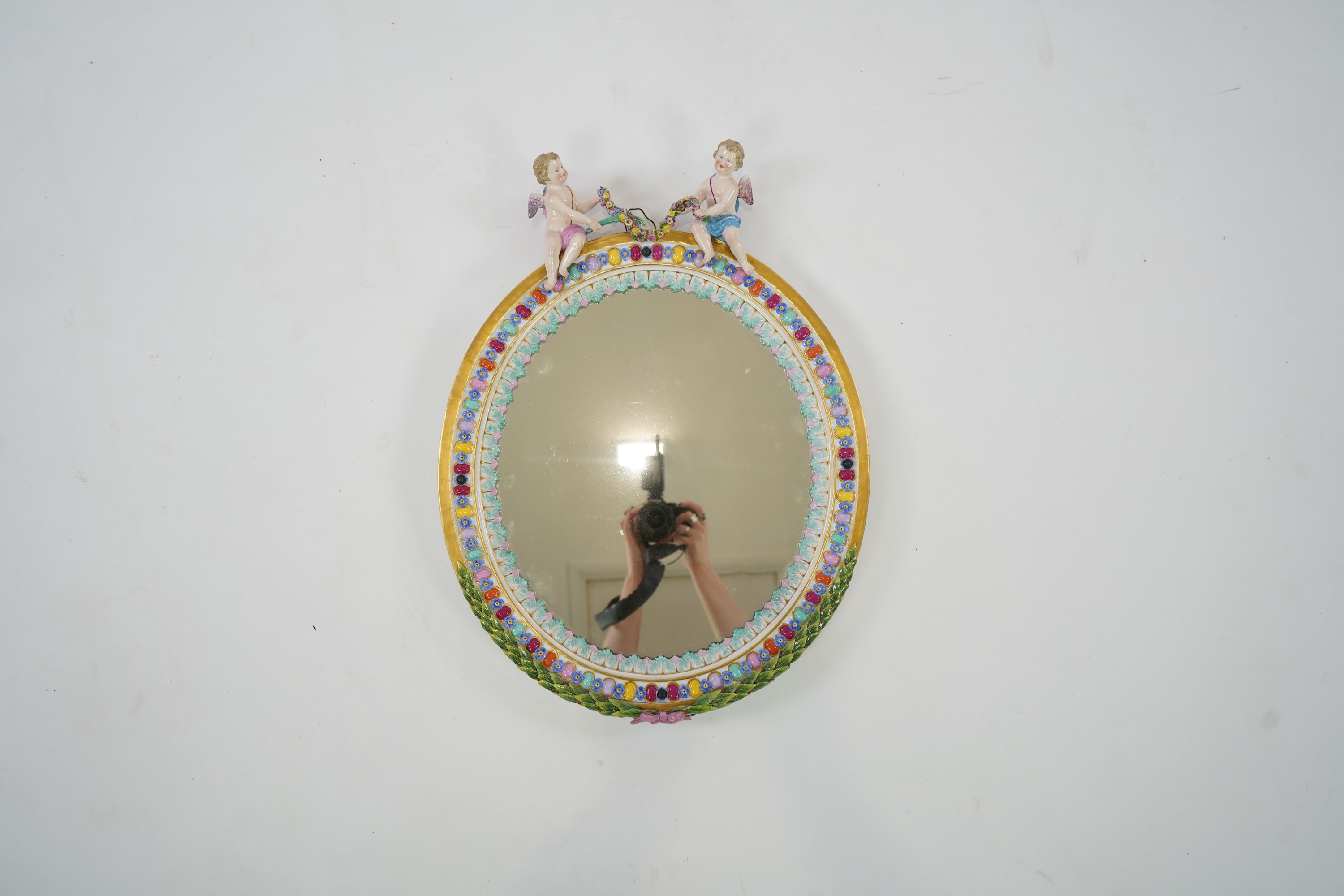 A Meissen figural oval mirror, late 19th century